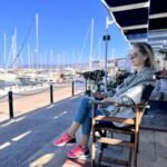 Relaxing at a marina café in Cyprus with yachts and sea views
