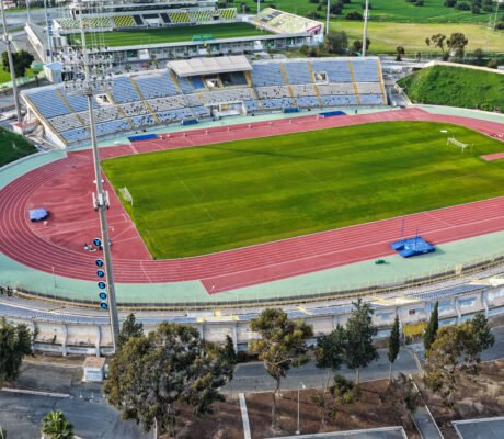 Aerial view of GSZ Stadium in Larnaca, Cyprus showing football field and athletics track.
