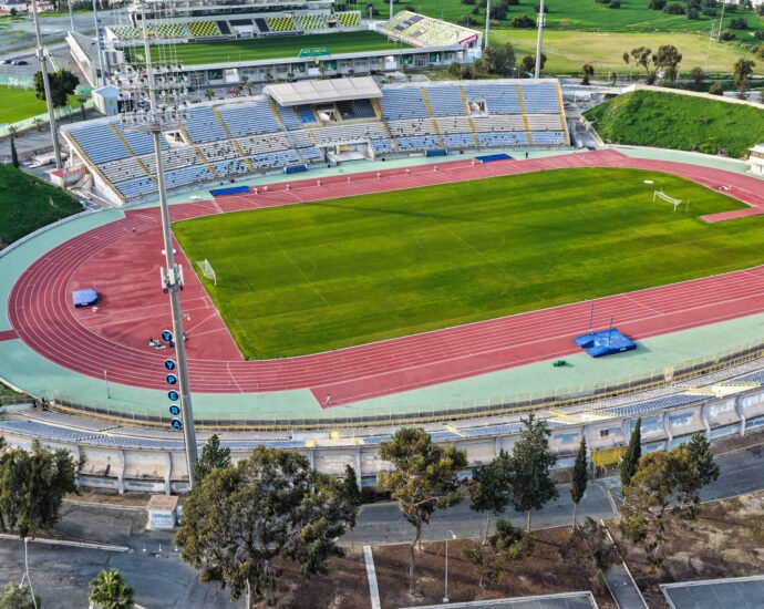Aerial view of GSZ Stadium in Larnaca, Cyprus showing football field and athletics track.