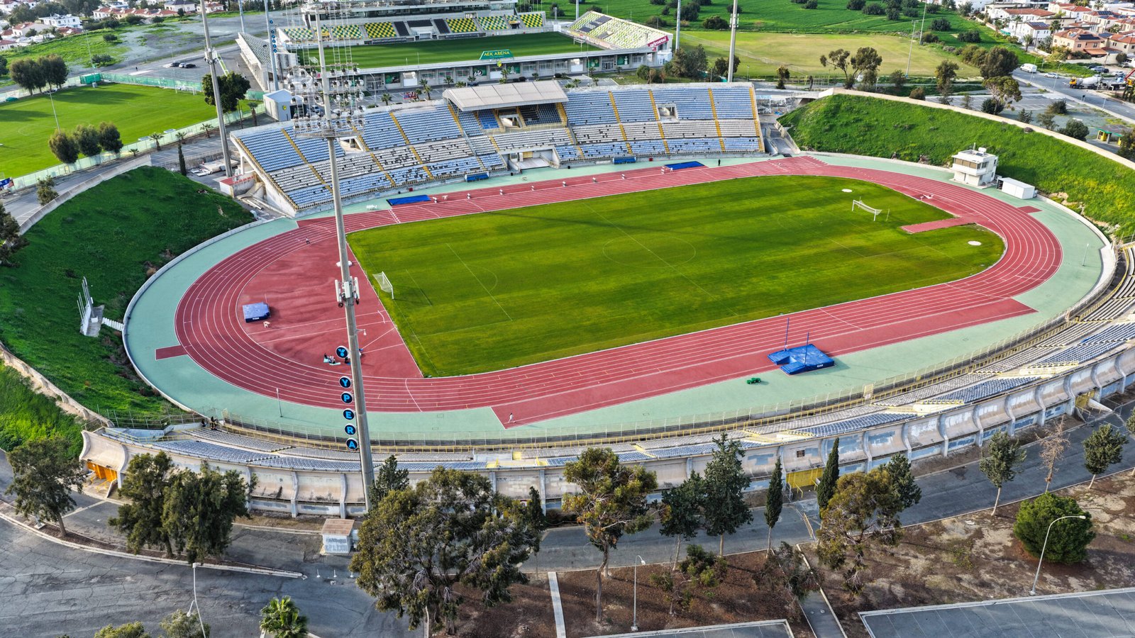 Aerial view of GSZ Stadium in Larnaca, Cyprus showing football field and athletics track.