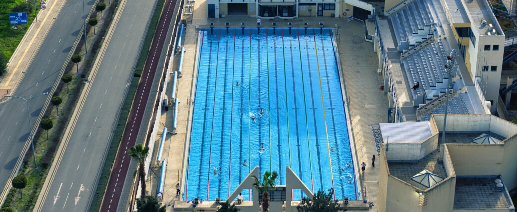 Aerial view of the Olympic swimming pool in Larnaca, Cyprus with 50 meter lanes and spectator stands.