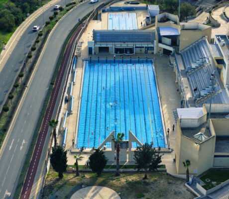 Aerial view of the Olympic swimming pool in Larnaca, Cyprus with 50 meter lanes and spectator stands.