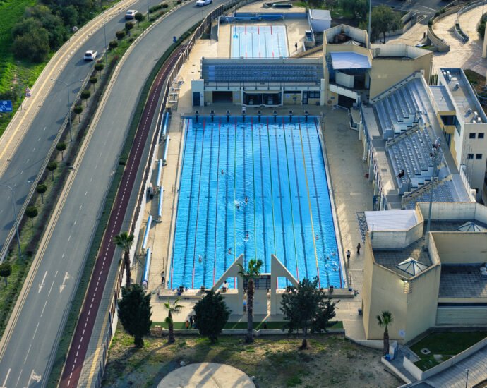 Aerial view of the Olympic swimming pool in Larnaca, Cyprus with 50 meter lanes and spectator stands.
