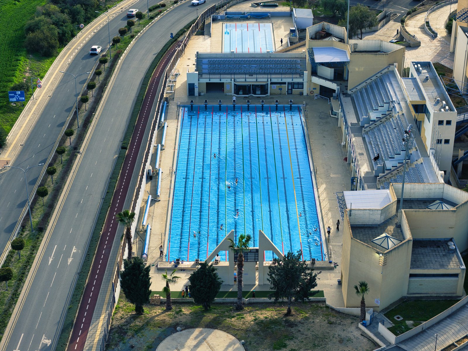 Aerial view of the Olympic swimming pool in Larnaca, Cyprus with 50 meter lanes and spectator stands.